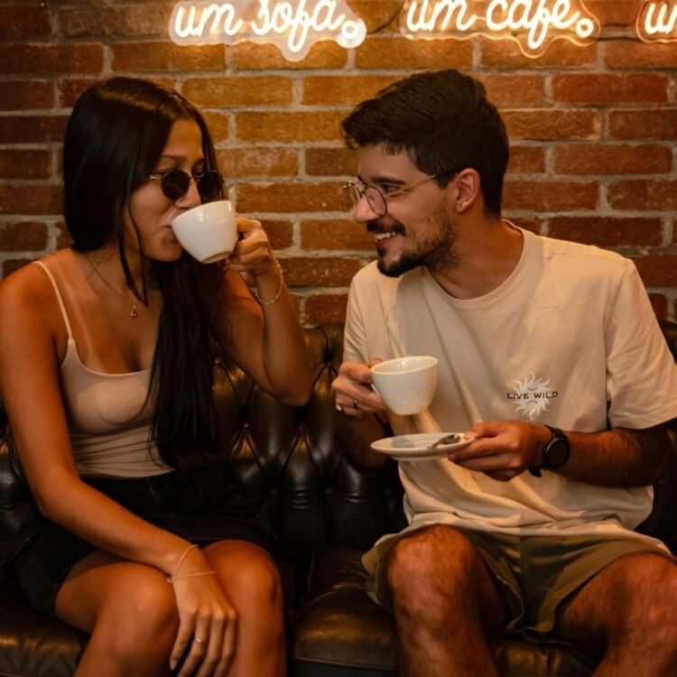 Smiling Pair Drinking Coffee in a Cafe
