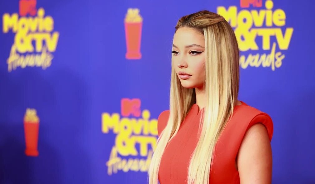 Madelyn Cline posing in a red dress