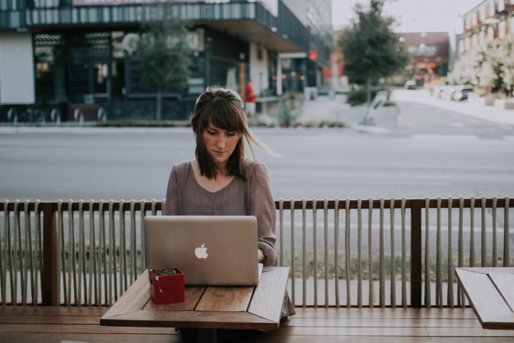 Woman in grey shirt working remotely