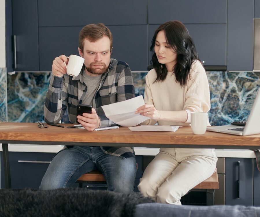 A Couple Surprise Facial Expression Looking at a Document
