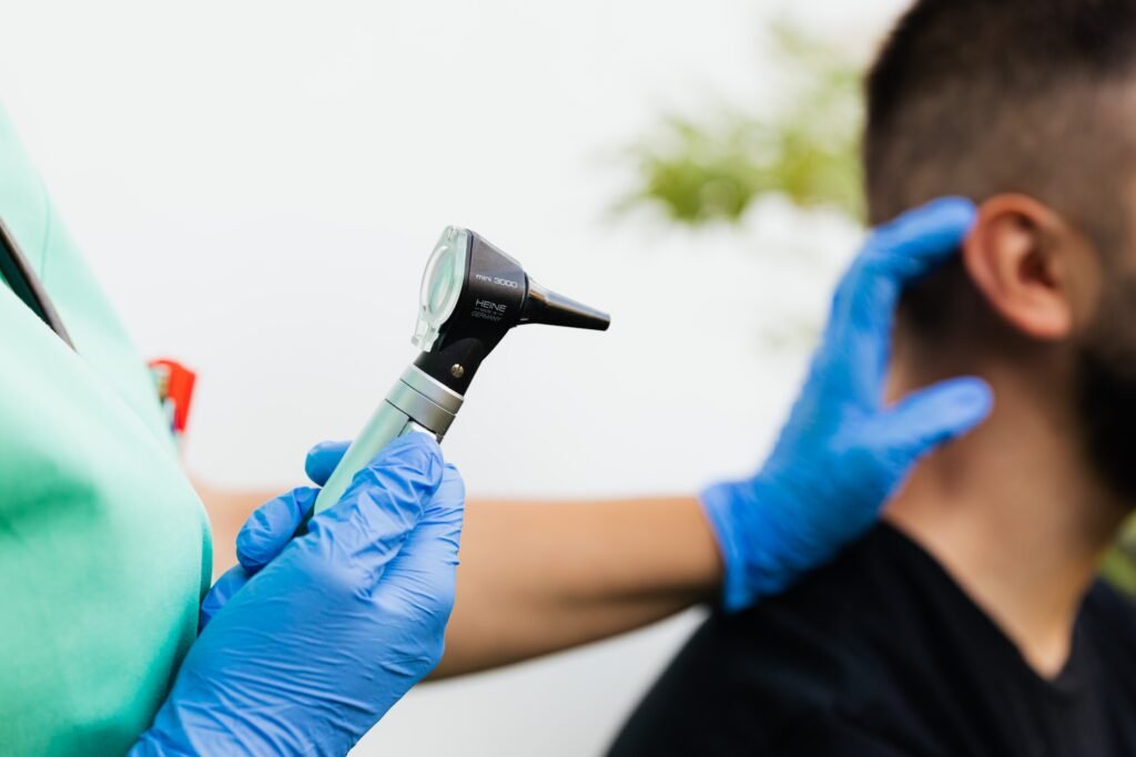 Medical practitioner checking patients ear