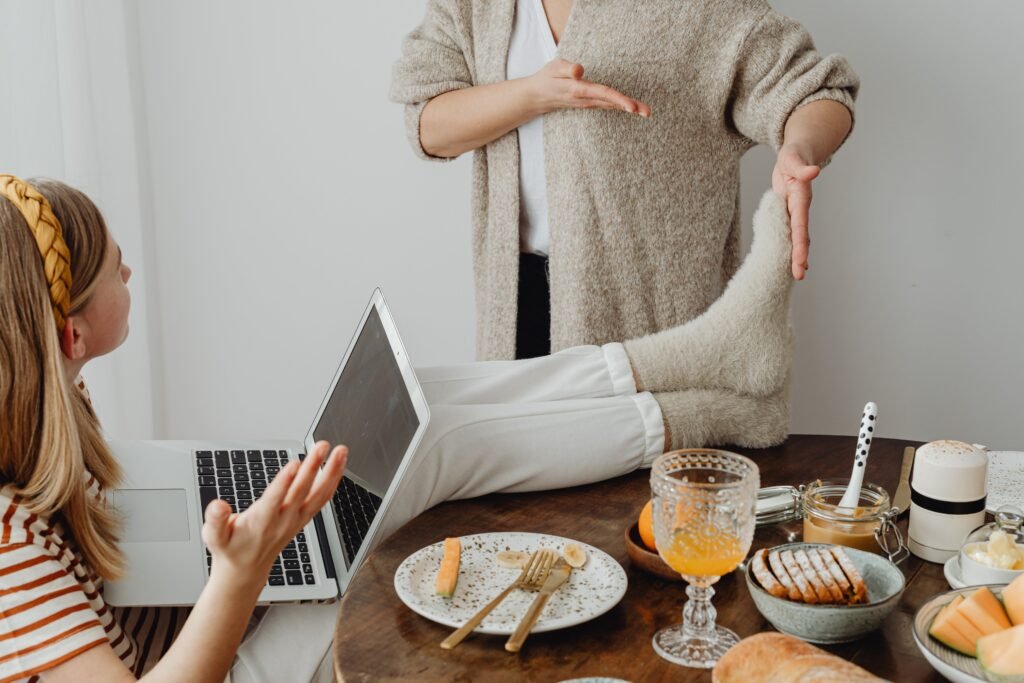 An Annoyed Woman On Another Person's Feet On Table