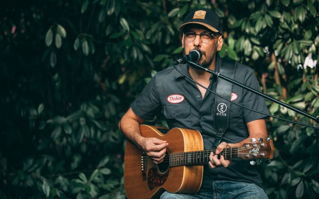Man Singing and Playing a Guitar photo kelian.pfl