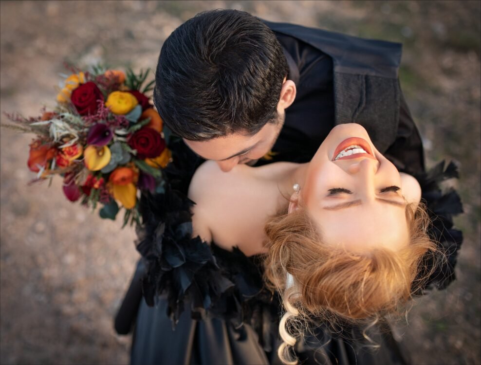 Couple having a cuddle holding flowers