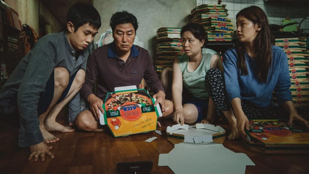 Choi Woo-shik, Song Kang-ho, Jang Hye-jin, and Park So-dam in Parasite.