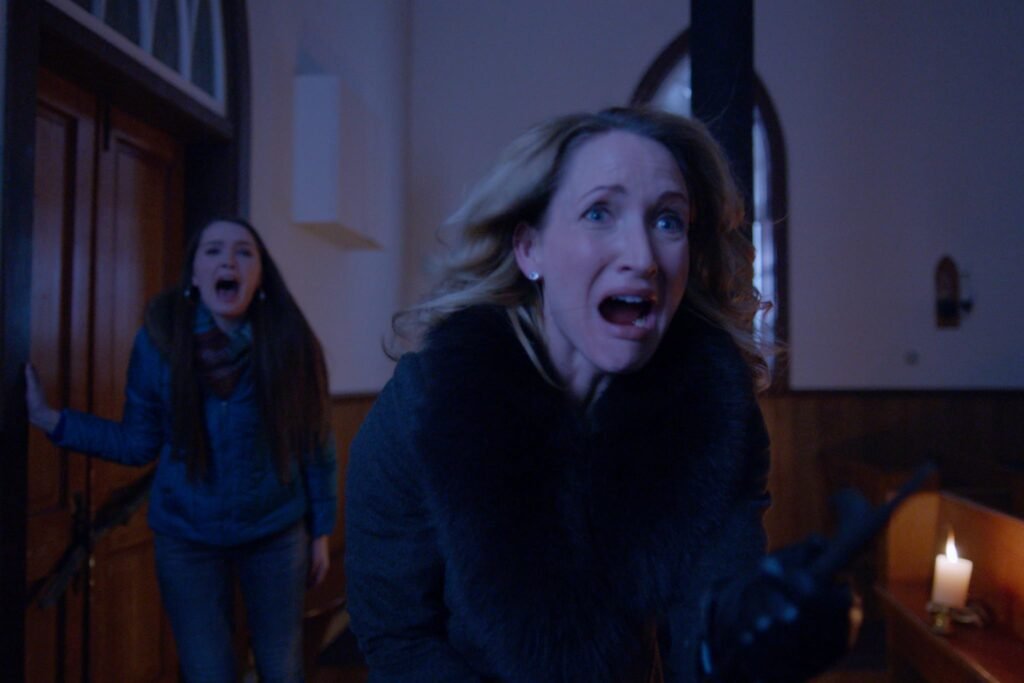 Michelle Nolden and Amy Forsyth in A Christmas Horror Story (2015)