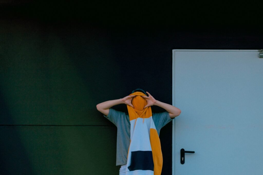 Man covering his face with a sweater