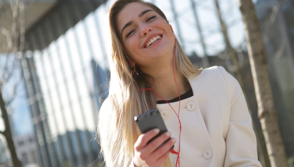 Woman laughing with a mobile phone in hand