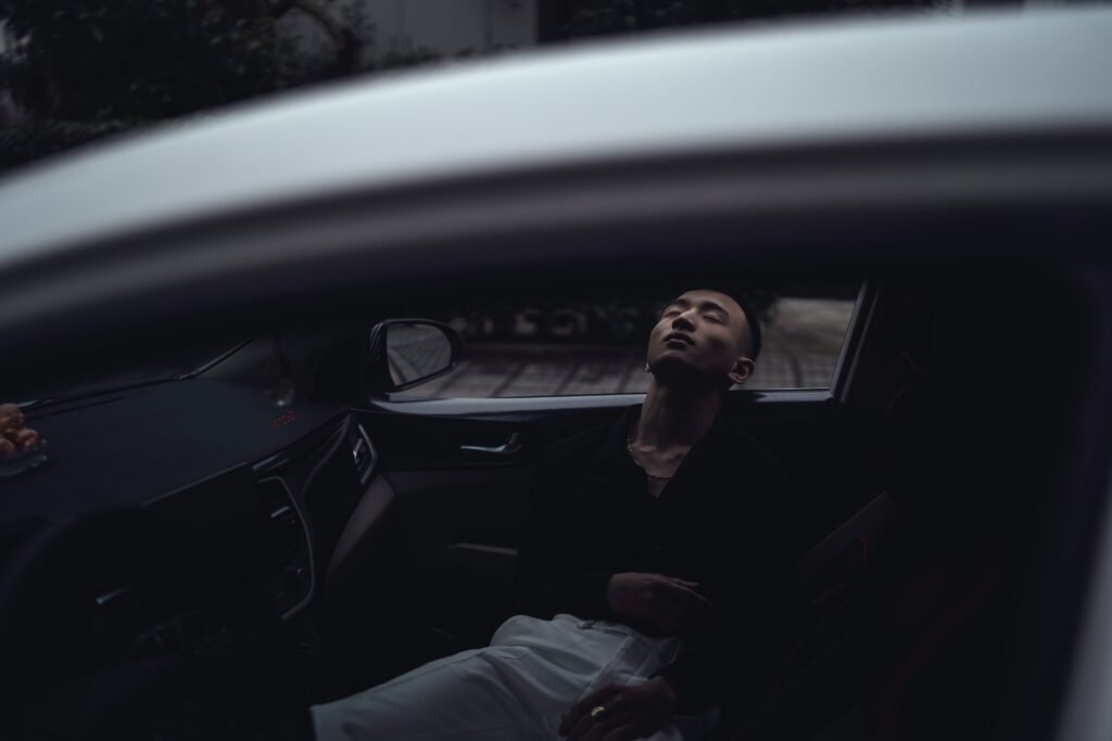 Man sleeping in a car
