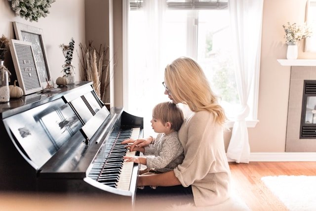 Woman and child playing piano