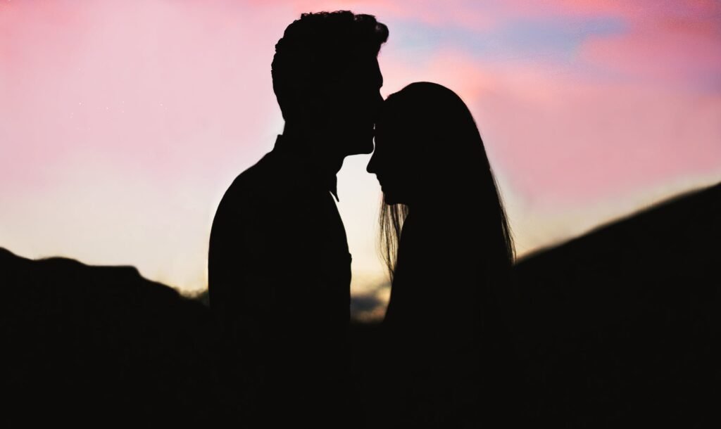 Silhouette of a man and a woman embracing
