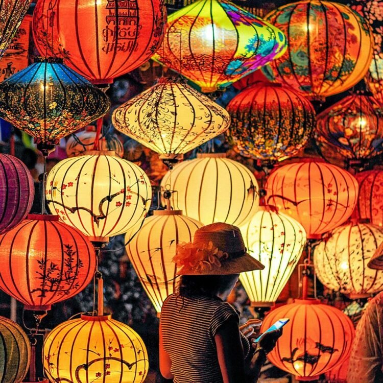 Person Standing Near Assorted-color Paper Lanterns
