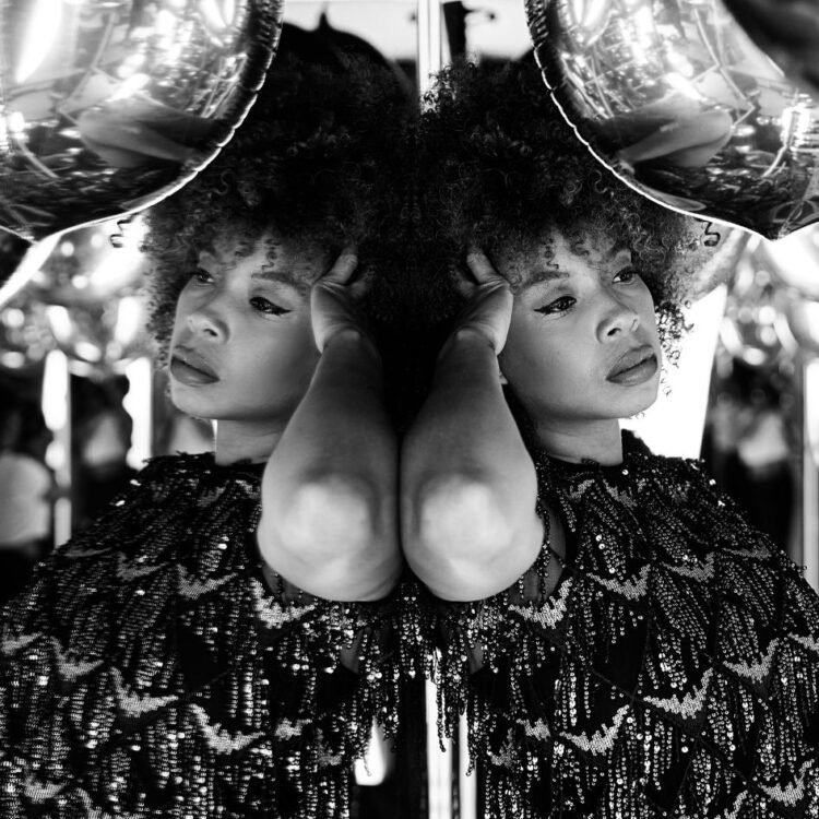 A woman in a mirror with a ball in her hand
