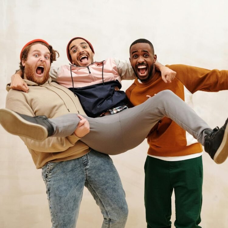 Three Men Standing While Laughing