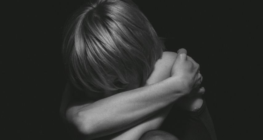 Photo of a Person Hugging Self