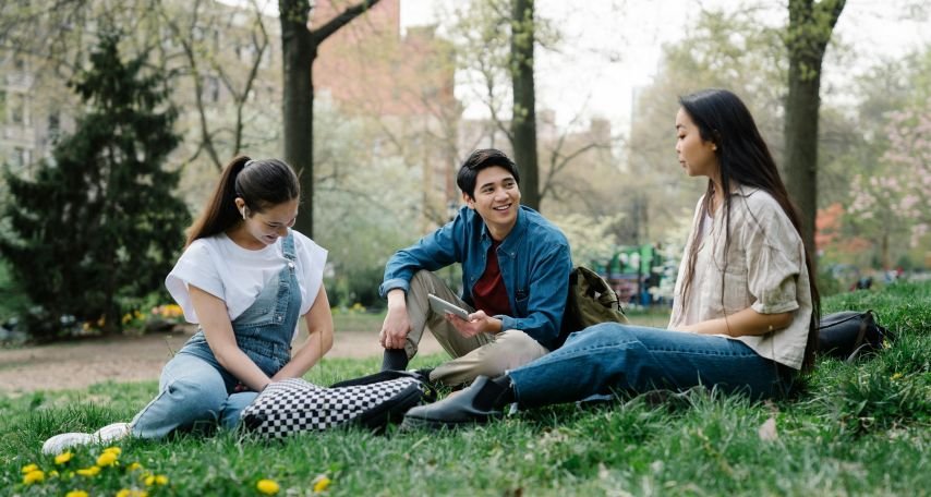 Group of Friends Sitting on the Grass Talking