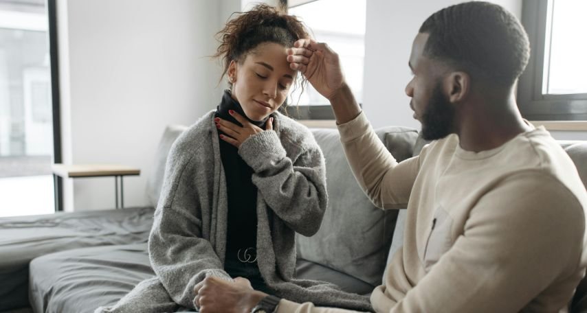 Man Checking Woman's Temperature