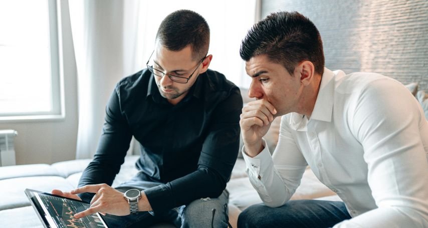 Two Men Discussing Graph on iPad