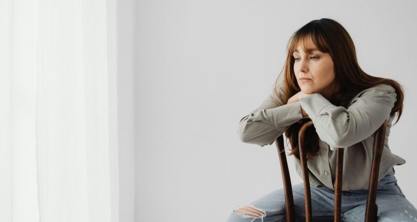 Woman in Gray Long Sleeves Sitting on a Chair
