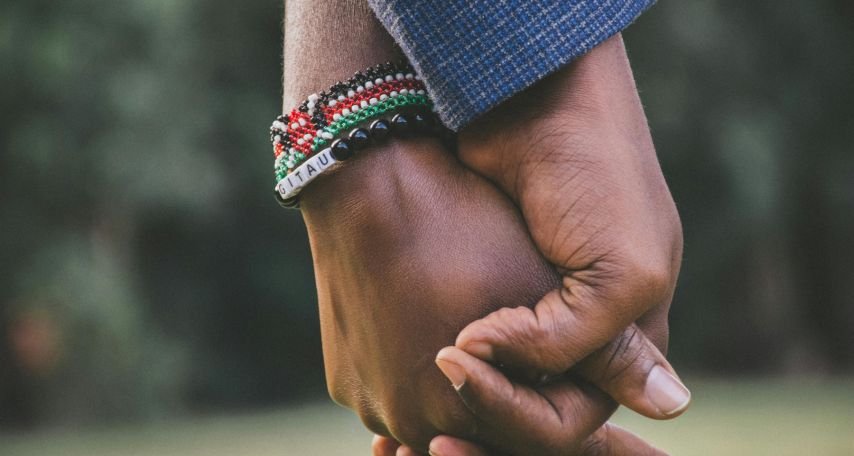 close-Up Photo of Two Person's Holding Hands
