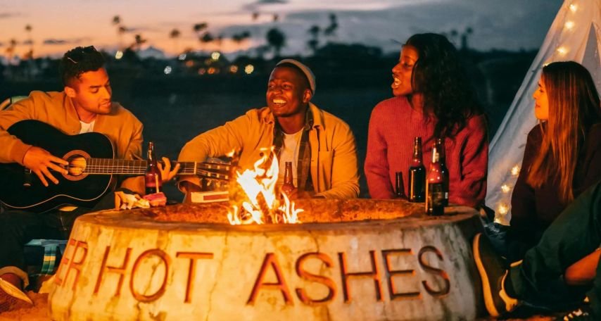 Group of Friends Listening to the Man Playing the Guitar
