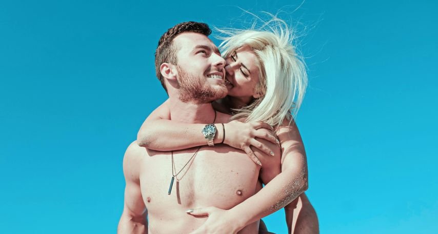 Smiling Woman Piggyback Riding Smiling Man

