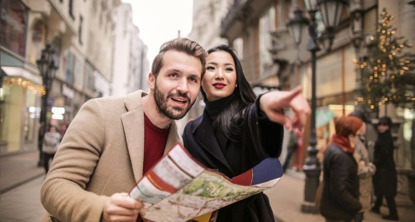 Man in Brown Suit Standing Beside Woman Wearing Black Coat