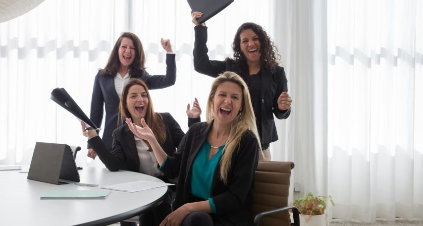 Happy Women by a Conference Room Table