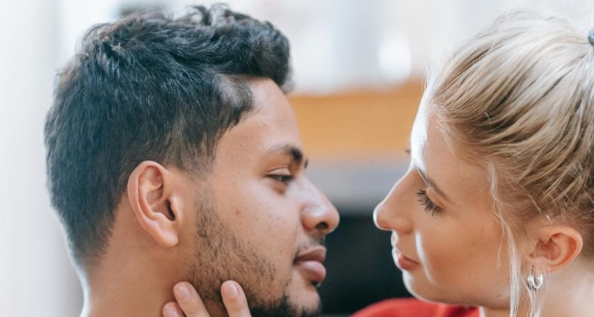 Man in Red Long Sleeved Shirt Looking at Woman

