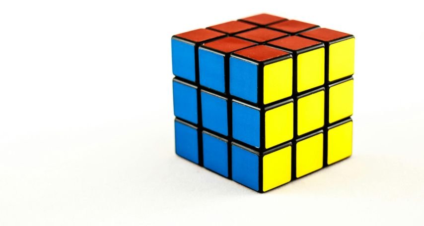 Rubik Cube Lying on White Background
