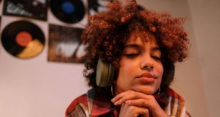 Woman Listening to Music on Her Green Headphones