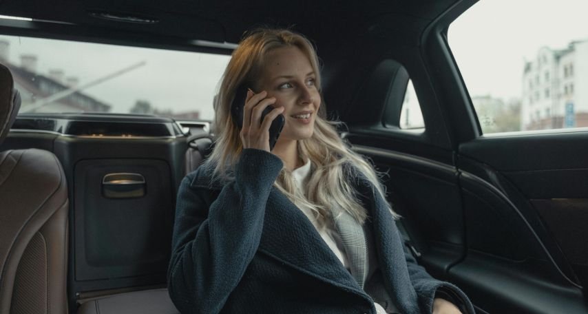 Woman in Gray Business Suit Sitting In A Luxurious Car
