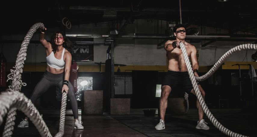 Man And Woman Holding Battle Ropes
