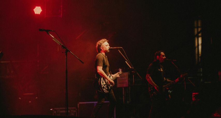 Band Singing on Stage at Rock Concert

