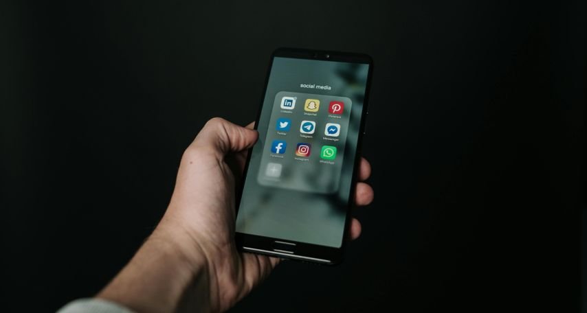 Photo of Hand Holding a Black Smartphone
