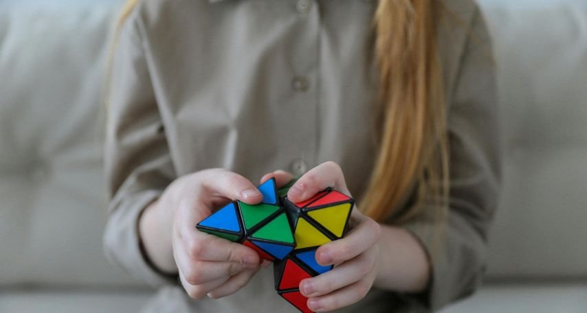 Girl showing bright brainteaser in hands
