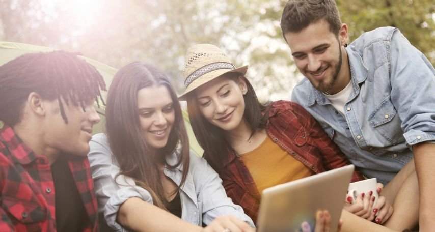 Cheerful woman showing friends social media feed
