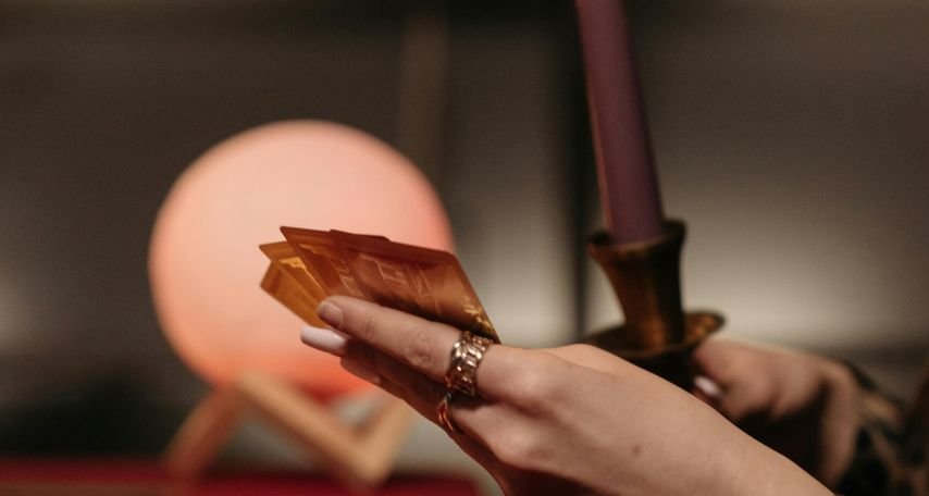 A Person Holding Tarot Cards
