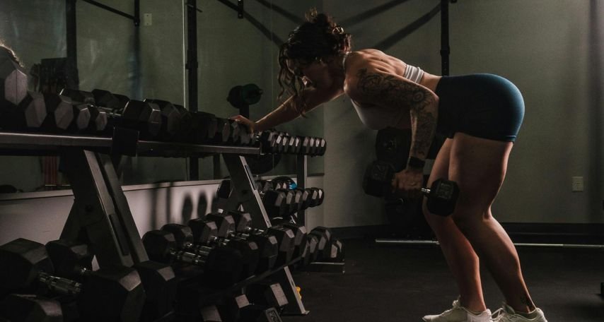 Woman Lifting Weights in a Gym