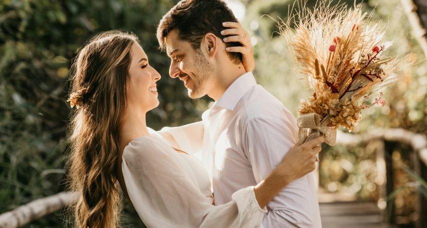 Bride and groom embracing outdoors