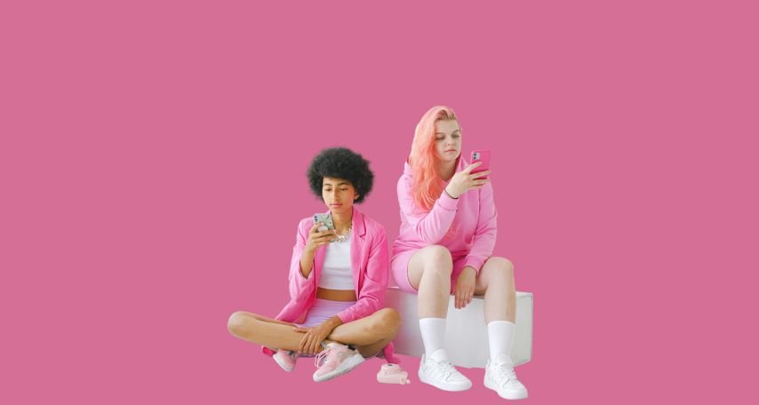 Trendy teenagers using smartphones in studio