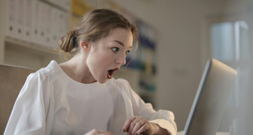 Woman in White Long Sleeve Shirt Using Silver Laptop Computer

