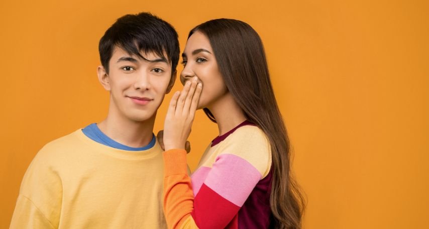 Woman Whispering in Mans Ear
