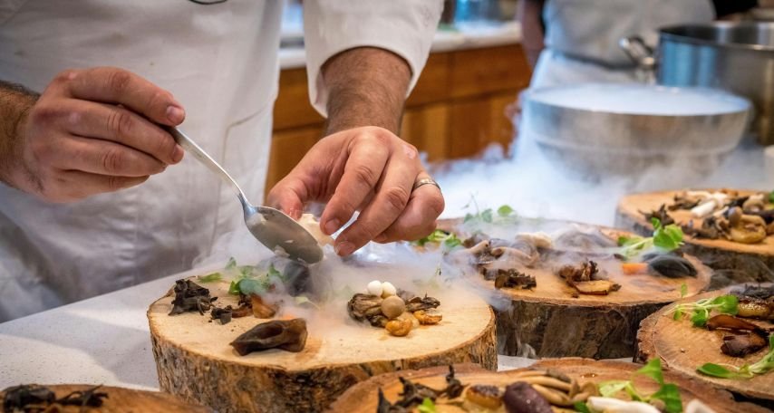 Chef Preparing Vegetable Dish on Tree Slab
