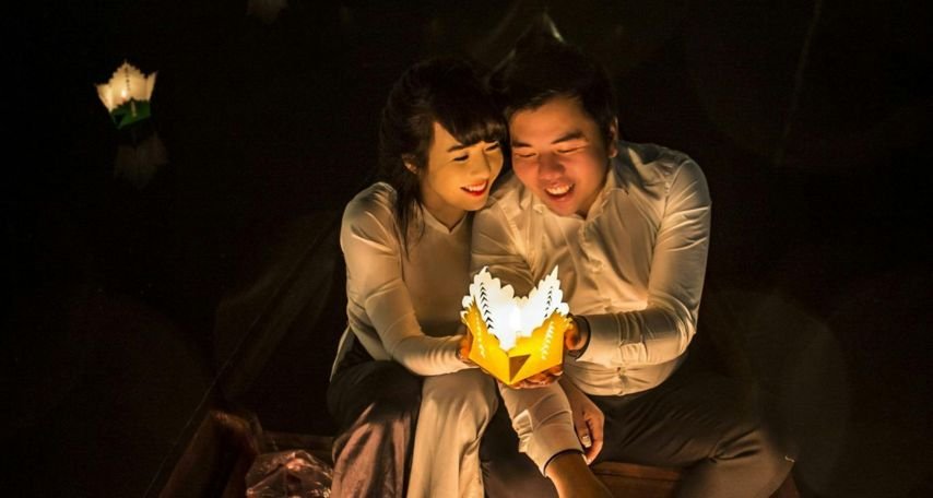Couple Sitting Holding Paper Lamp