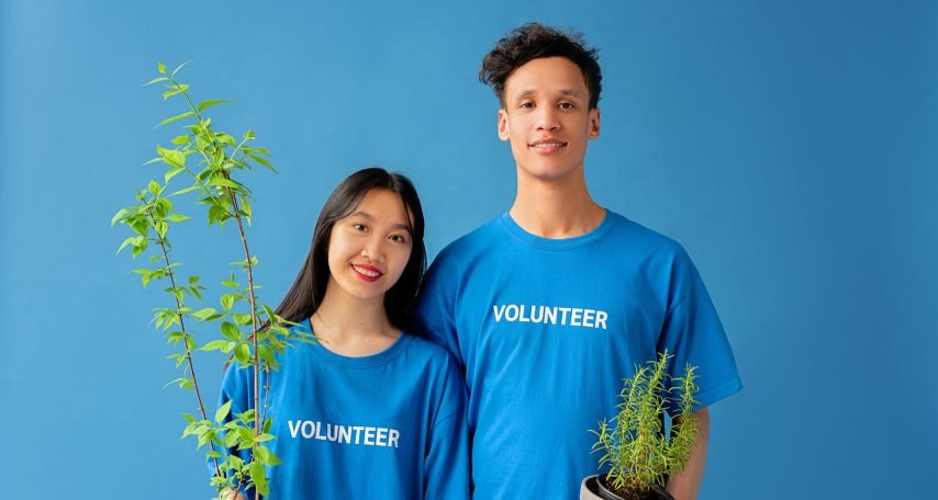 Couple Holding Potted Plants