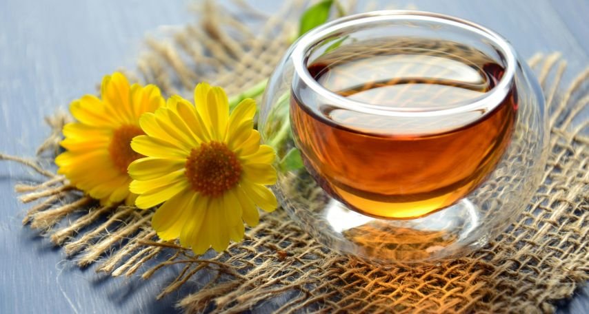 Clear Glass Bowl Beside Yellow Flower
