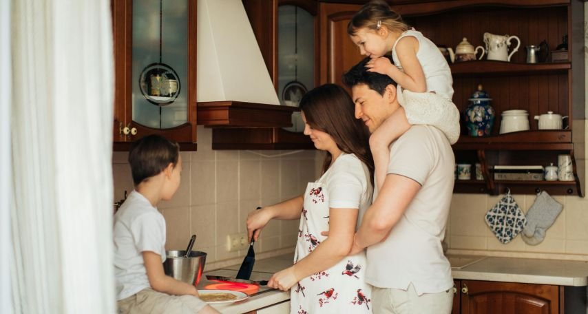 Photo of Woman Cooking Near Her Family
