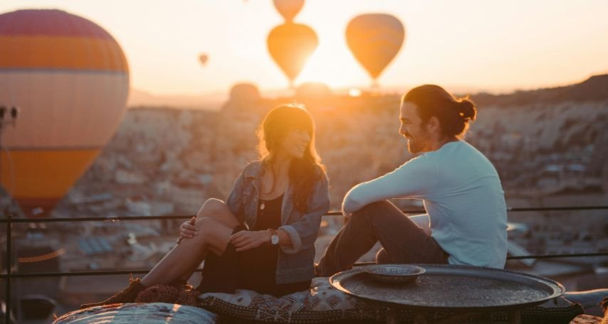 Man and Woman on Rooftop During Sunset
