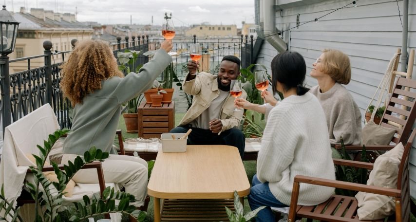 People Drinking Wine on House Veranda
